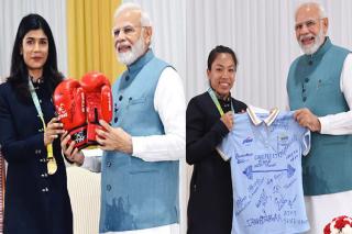 Nikhat gifts PM Modi boxing gloves, Hima gives traditional gamocha